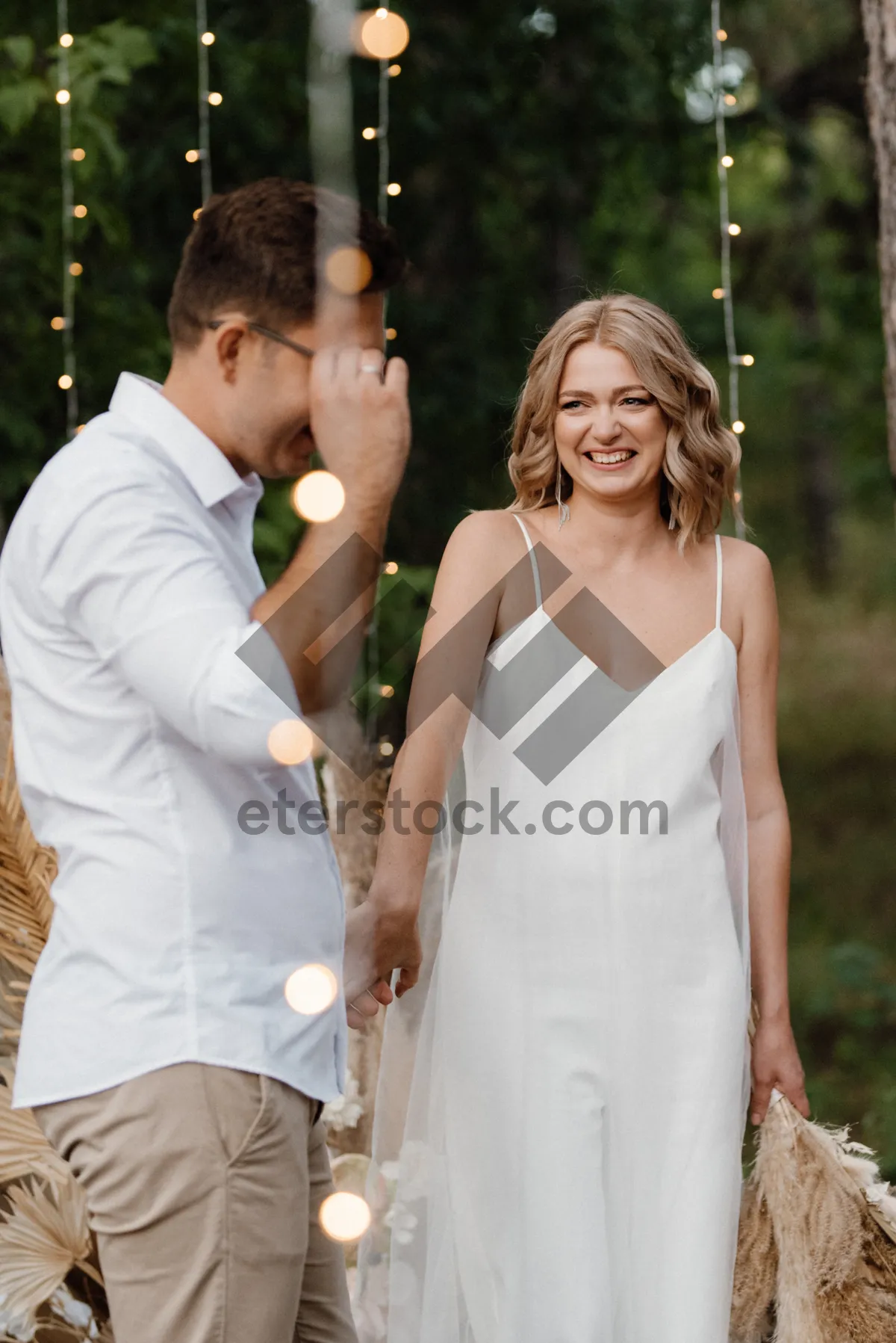 Picture of Happy Bride and Groom Celebrating Wedding Outdoors