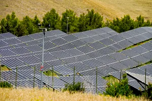 Solar panel array in sunny field generating electricity