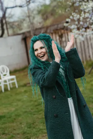 Attractive lady in fashionable winter outfit smiling in park