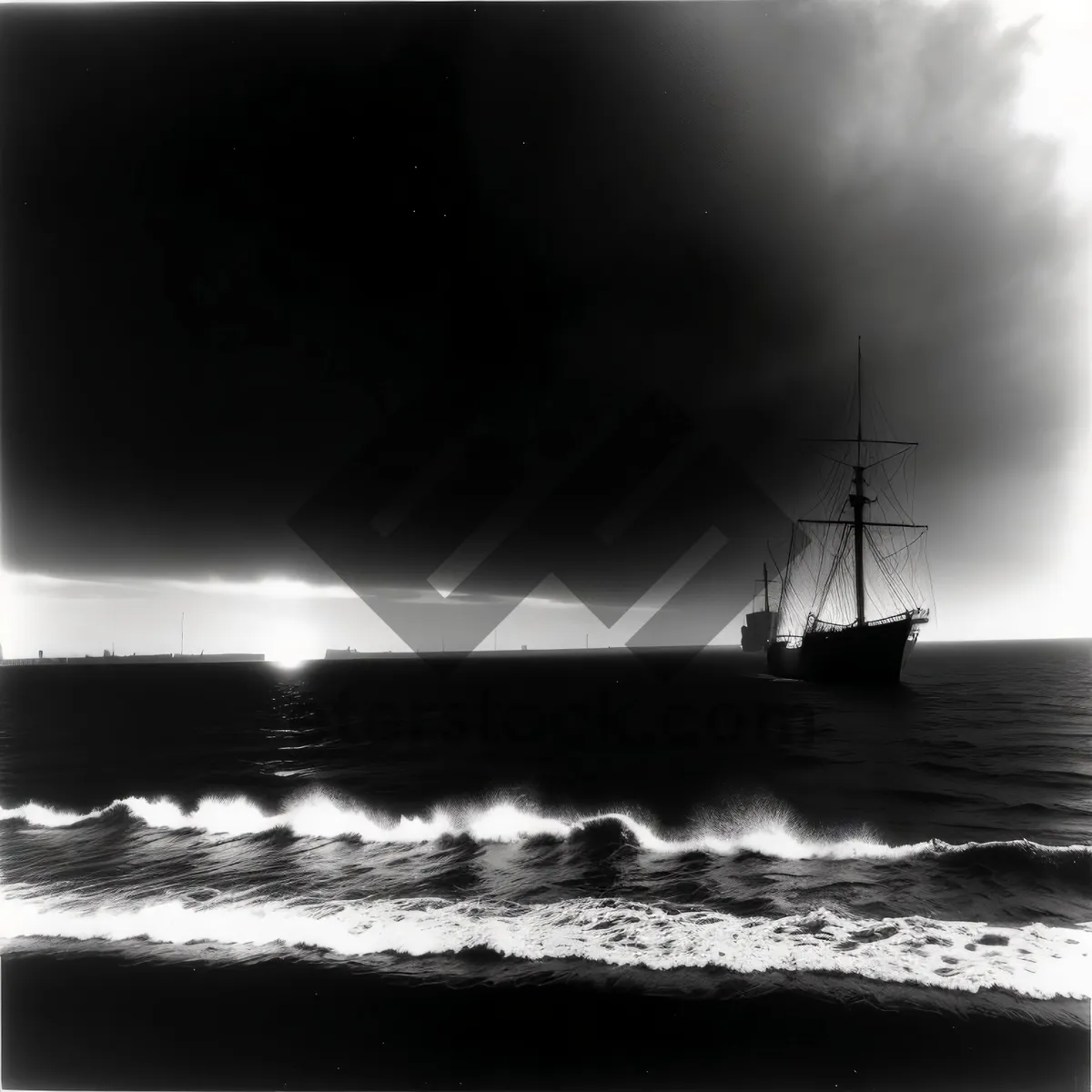 Picture of Pirate ship silhouette on ocean at sunset.