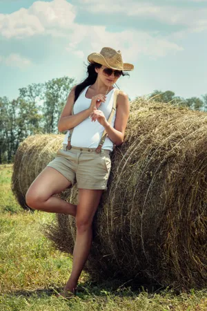 Attractive woman in wheat field enjoying summer freedom.