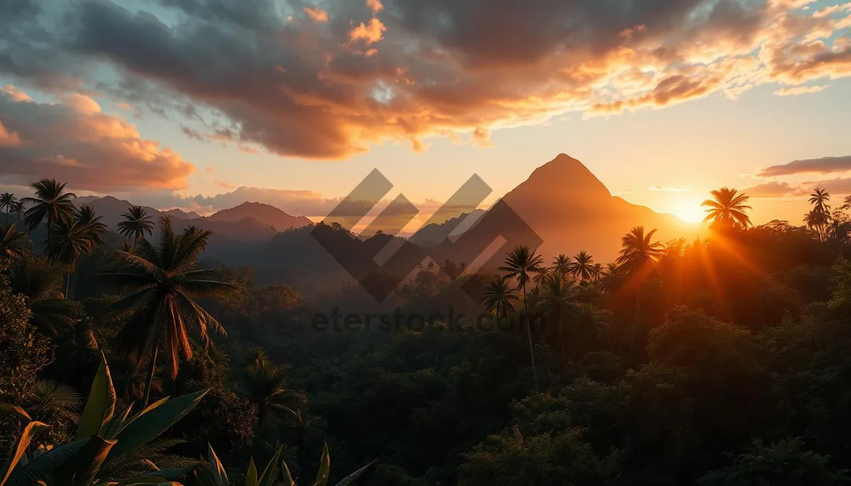 Picture of Orange sunset over mountain landscape with volcano silhouette