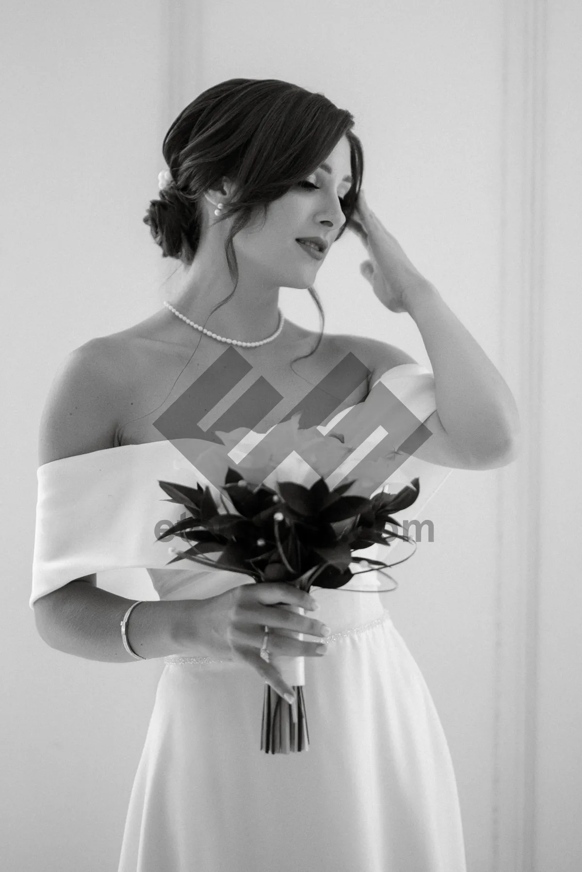 Picture of Elegant bride in satin gown with bouquet