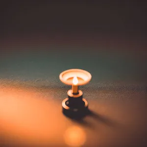 Lamp with illuminated light bulb and thumbtack
