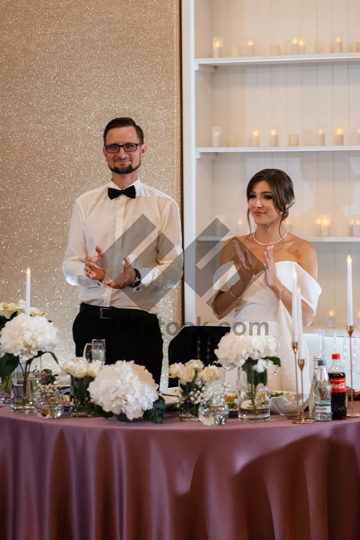 Picture of Happy newlyweds with bouquet at wedding celebration.