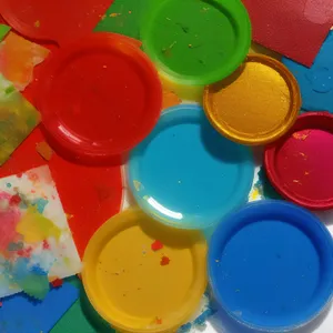 Colorful paint bottles in yellow container on counter tray.