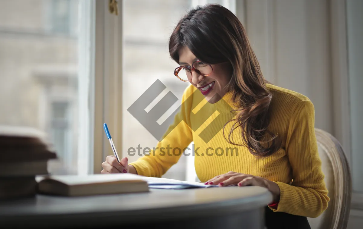 Picture of Happy businesswoman working on laptop in home office