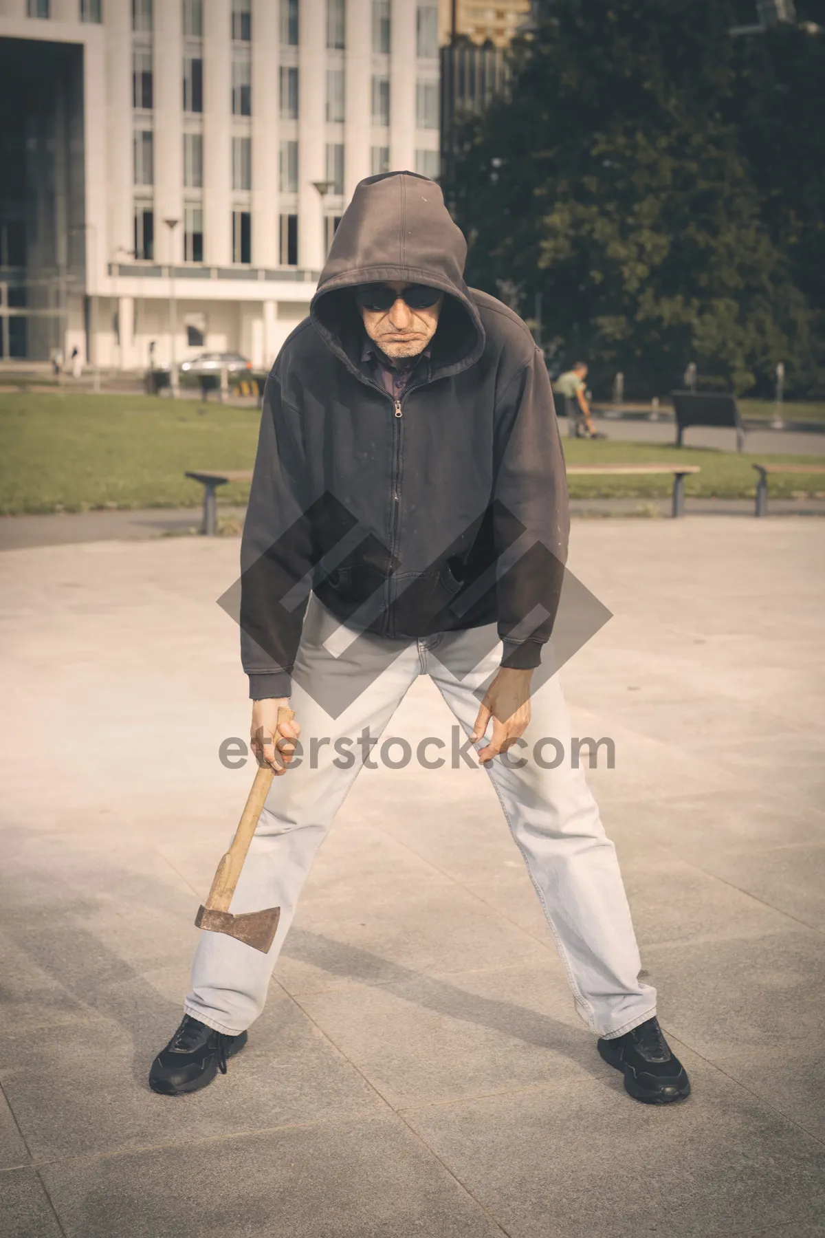 Picture of Male Golfer Swinging Club on Grass Course