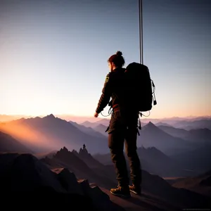 Adventurous Hiker Conquering Majestic Mountain Summit
