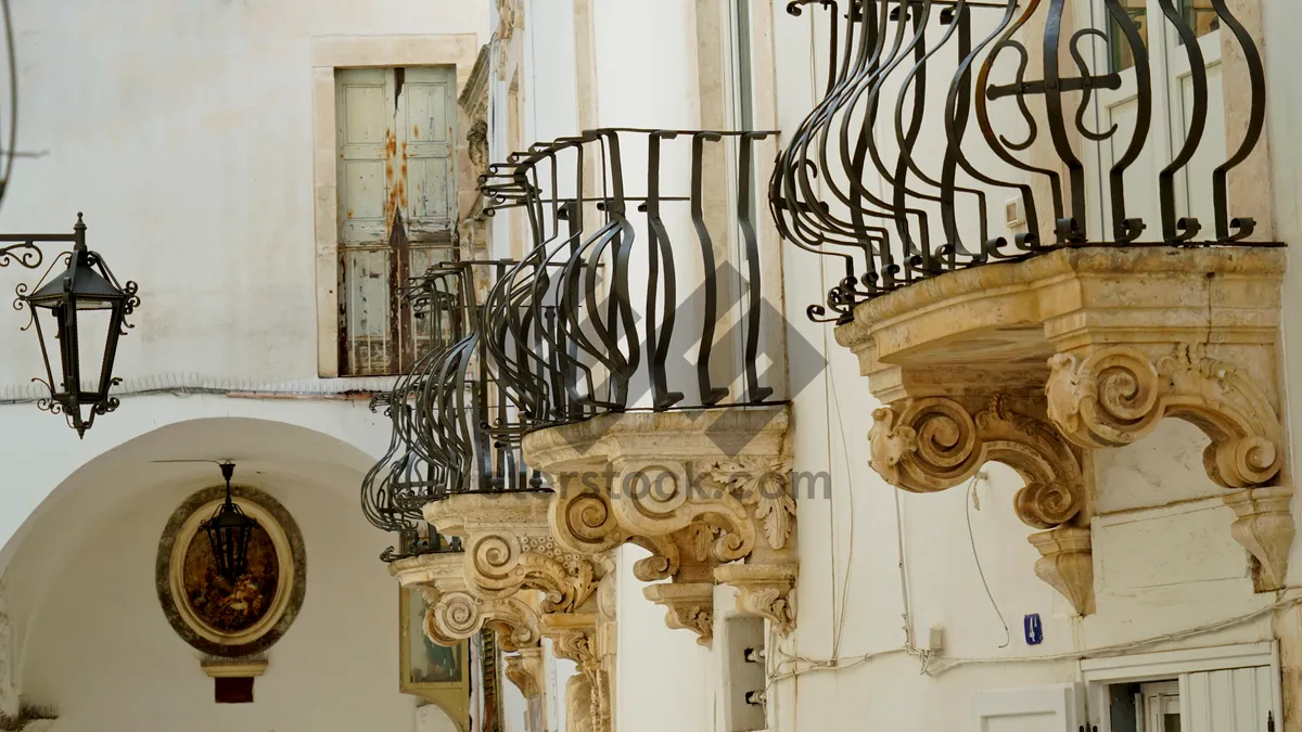 Picture of Old building with balcony and menorah sculpture on facade