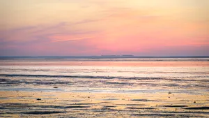 Tropical beach sunset reflection on water