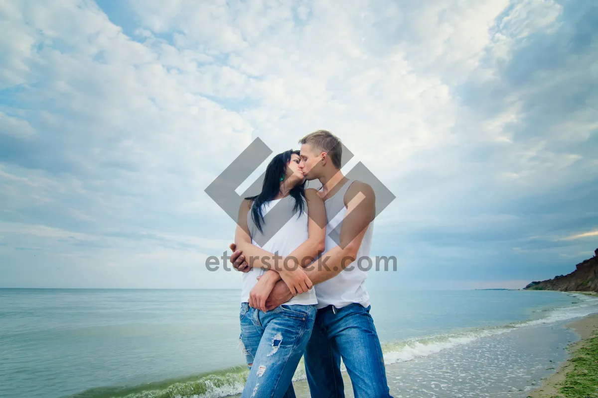 Picture of Happy Couple on Beach with Binoculars Watching Sunset