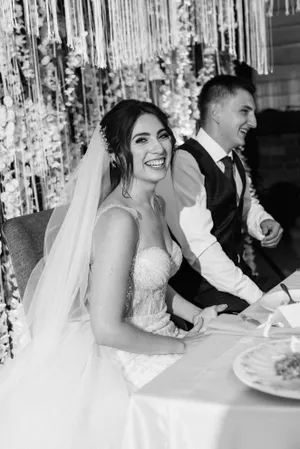 Happy Couple at Wedding with Bouquet of Flowers