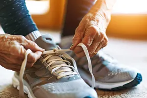 Person wearing leather running shoes for sportswear lifestyle.