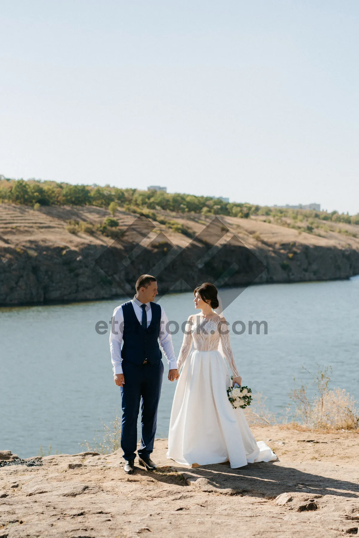 Picture of Man and bride on beach with ocean backdrop