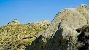 Mountain Range Scenery with Stone Megalith in Rural Landscape