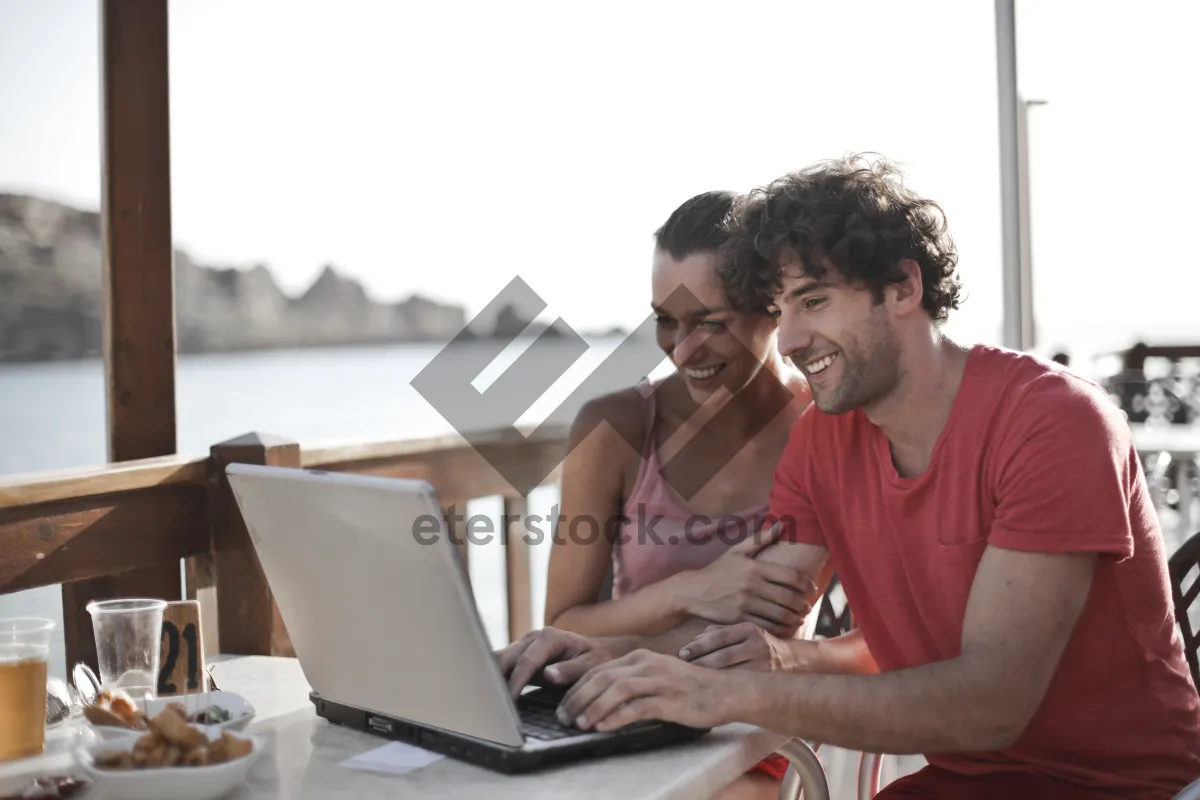 Picture of Happy man working on laptop at home office