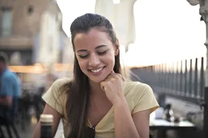 Smiling businesswoman in corporate office using phone