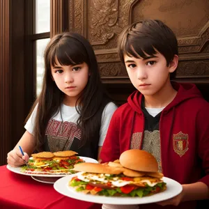 Happy Family Enjoying Delicious Dinner at Restaurant