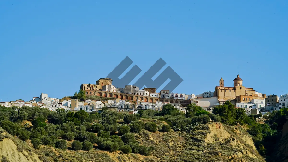 Picture of Medieval castle overlooking city skyline with ancient ruins.