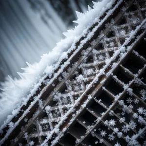 Frosty Metal Fence against Snowy Sky