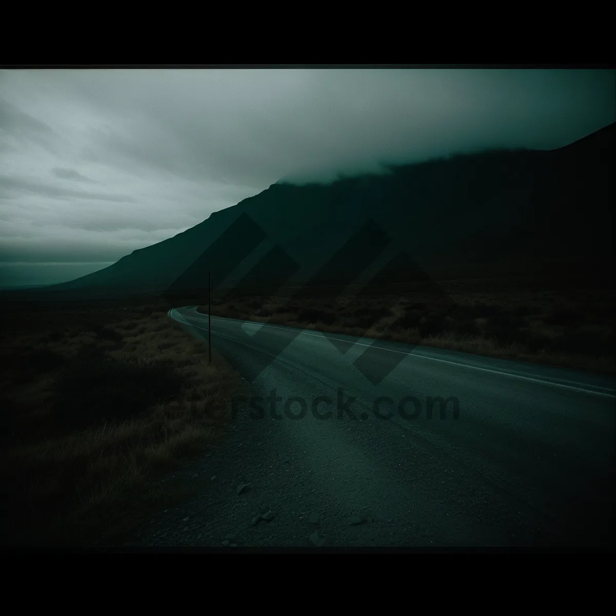 Picture of Scenic Sunlit Highway Through Mountainous Landscape