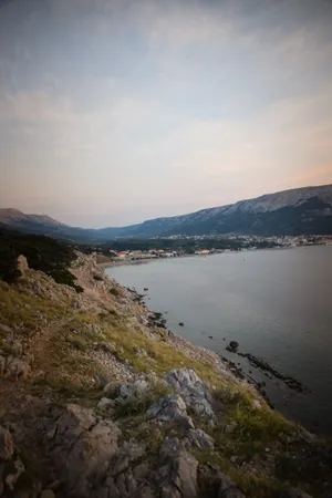 Mountain sunset over rocky cape with ocean view