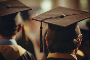 Attractive graduate holding umbrella in university graduation ceremony.