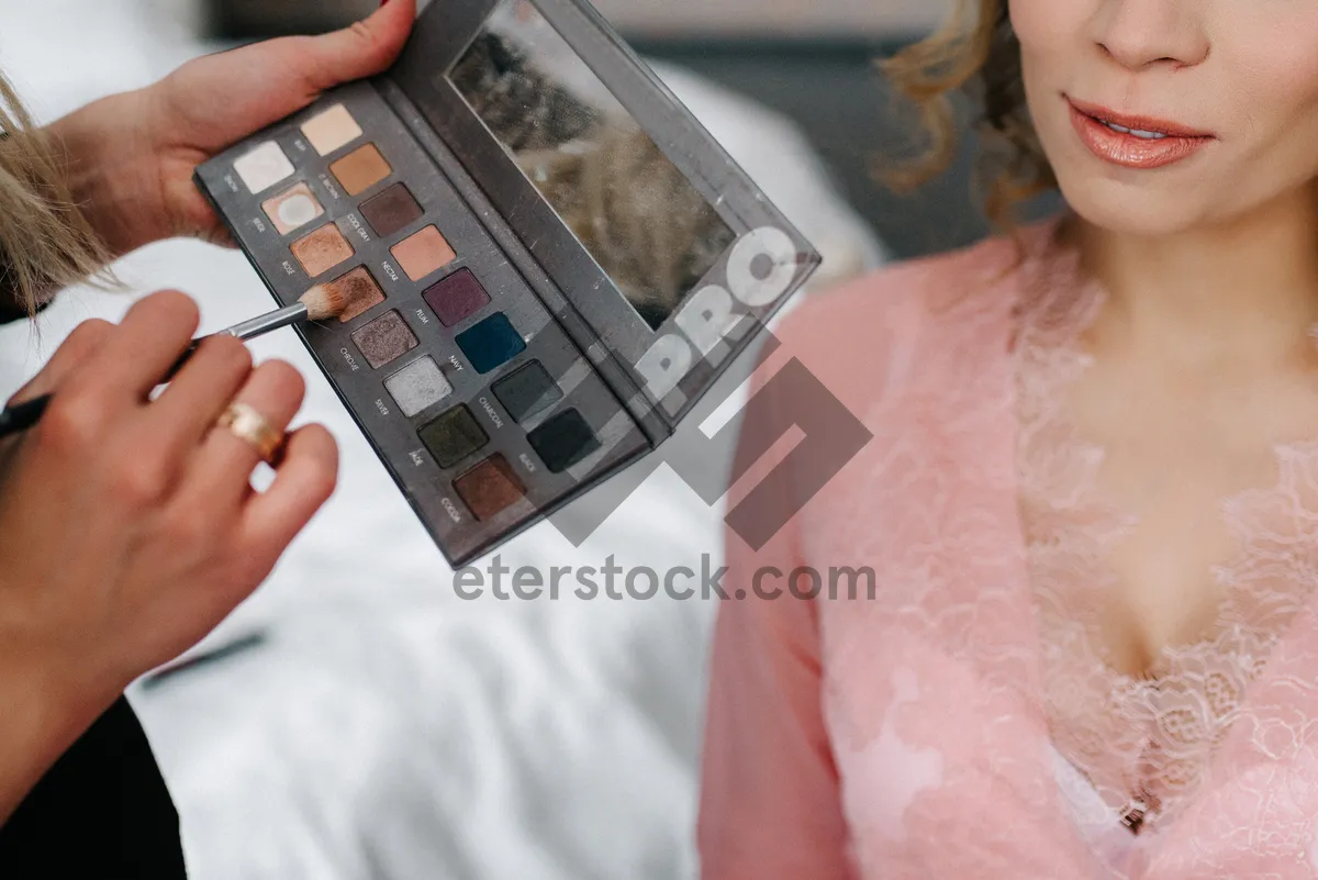 Picture of Laptop user working on business project with phone in hand.