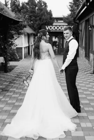 Happy couple celebrating wedding day with bouquet of flowers