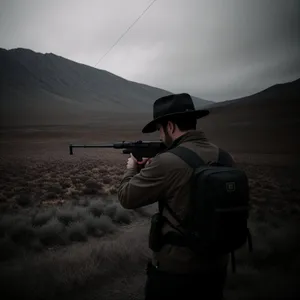 Mountain Man with Assault Rifle and Tripod"
or
"Male Shooter with Automatic Rifle on Tripod