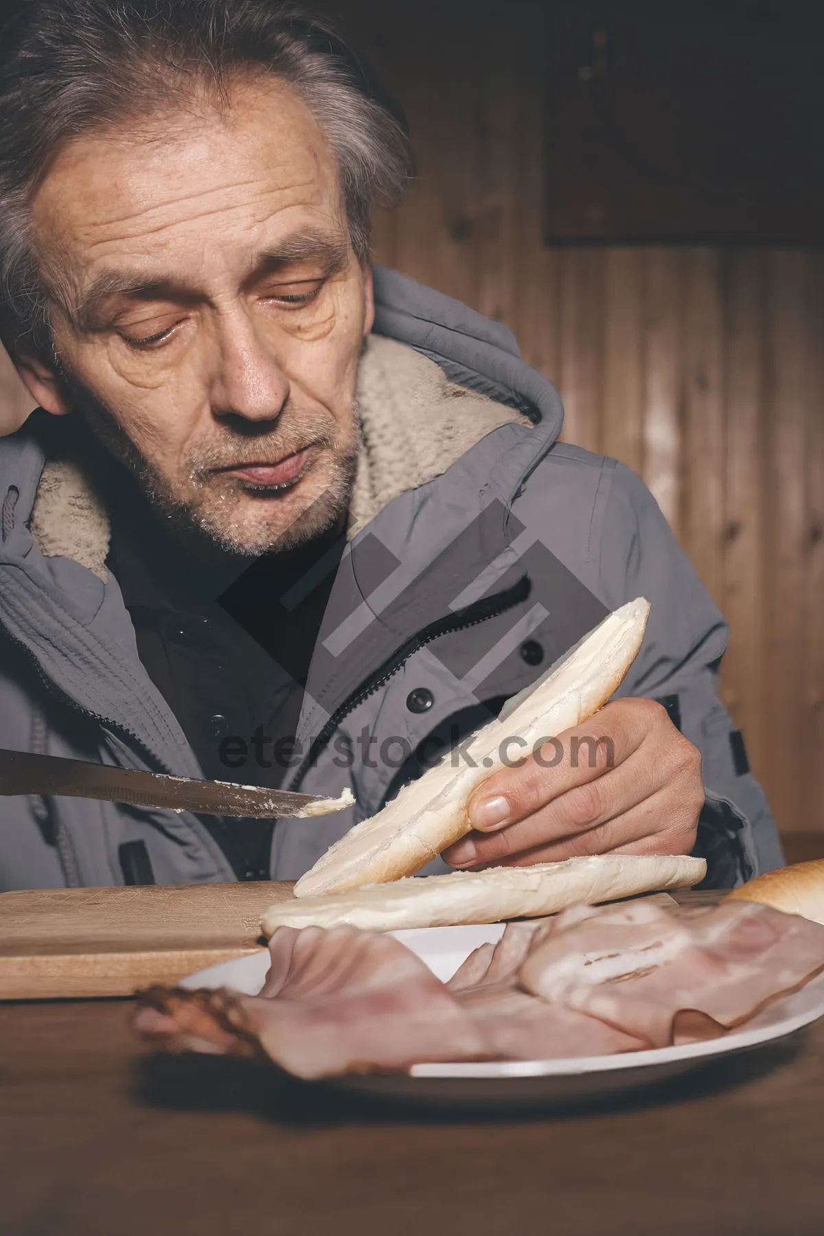 Picture of Happy elderly carpenter sitting at home with wife.