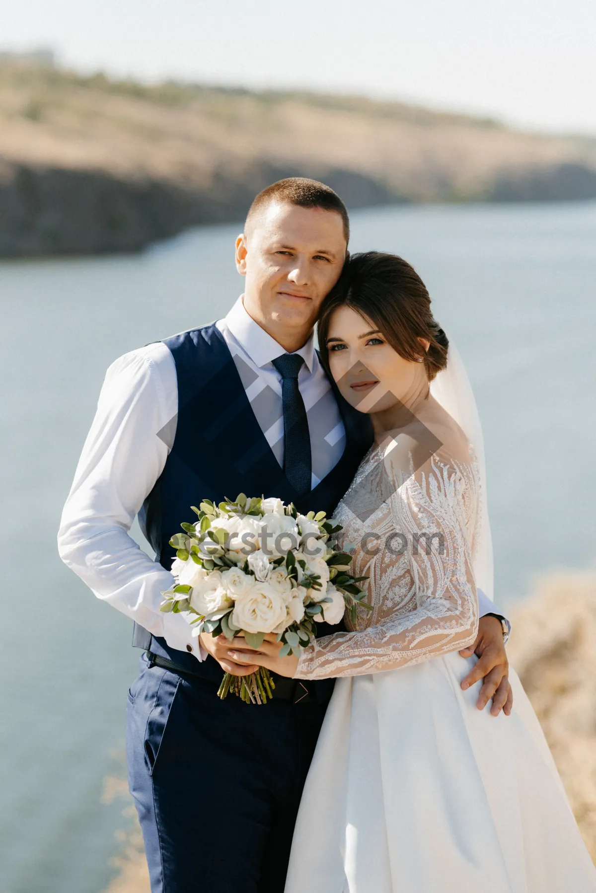 Picture of Happy newlywed couple celebrating love with flowers outdoors