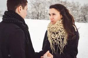 Attractive brunette lady smiling in fashionable coat