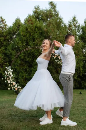 Happy newlywed couple in bridal attire outdoors