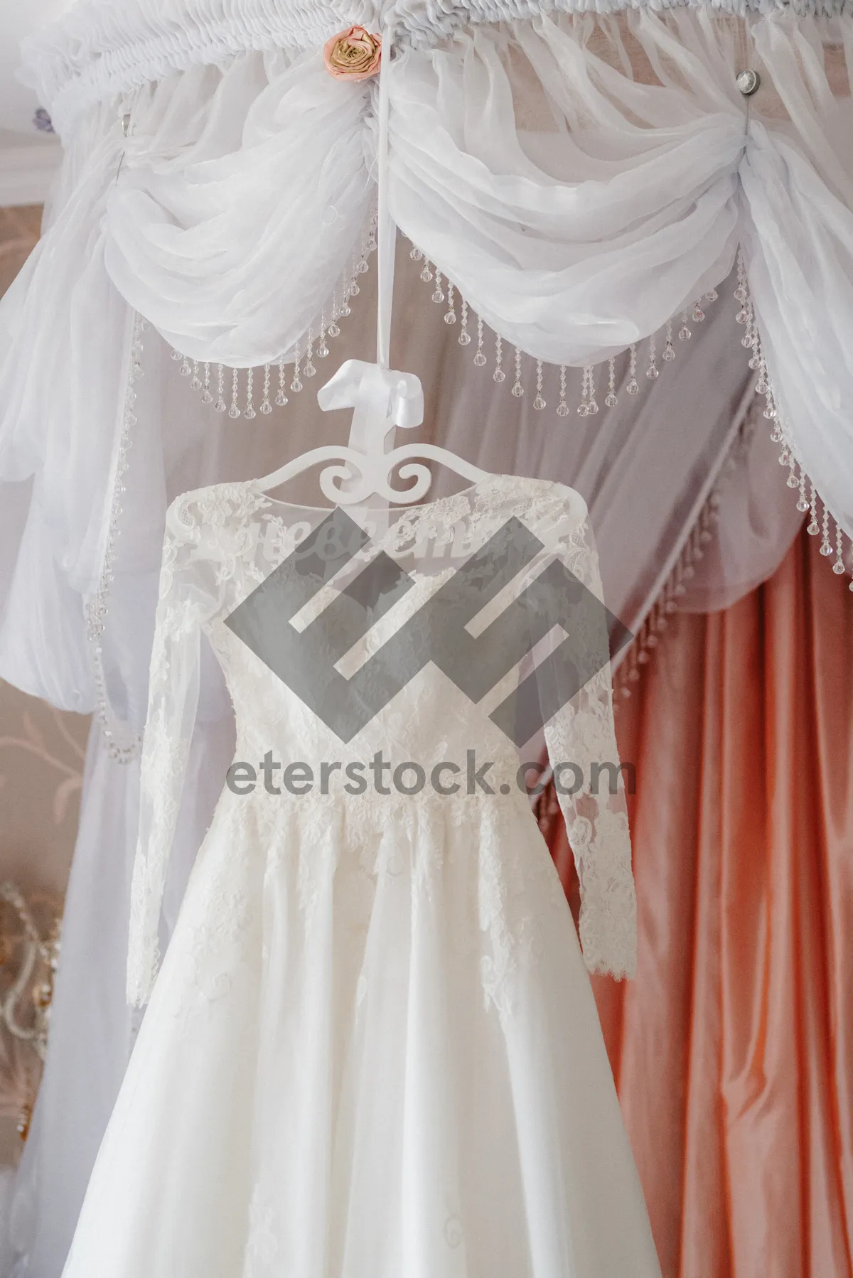 Picture of Happy bride in elegant wedding gown at boutique.