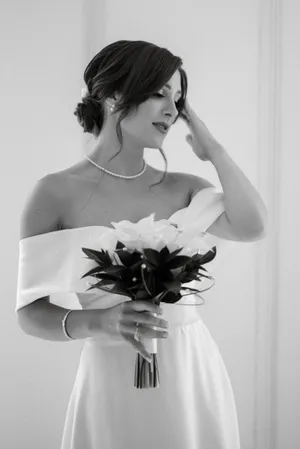 Elegant bride in satin gown with bouquet