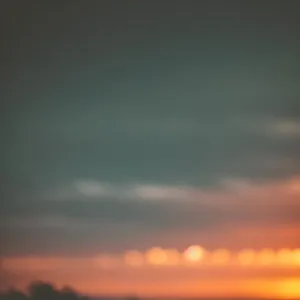 Golden Horizon: Sunlit Meadow in a Cloudy Landscape