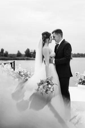 Happy newlywed couple celebrating outdoors with flowers