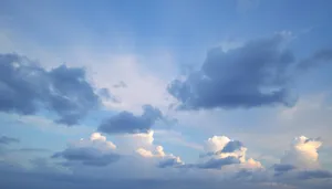 Soaring sunlit clouds in a clear blue sky