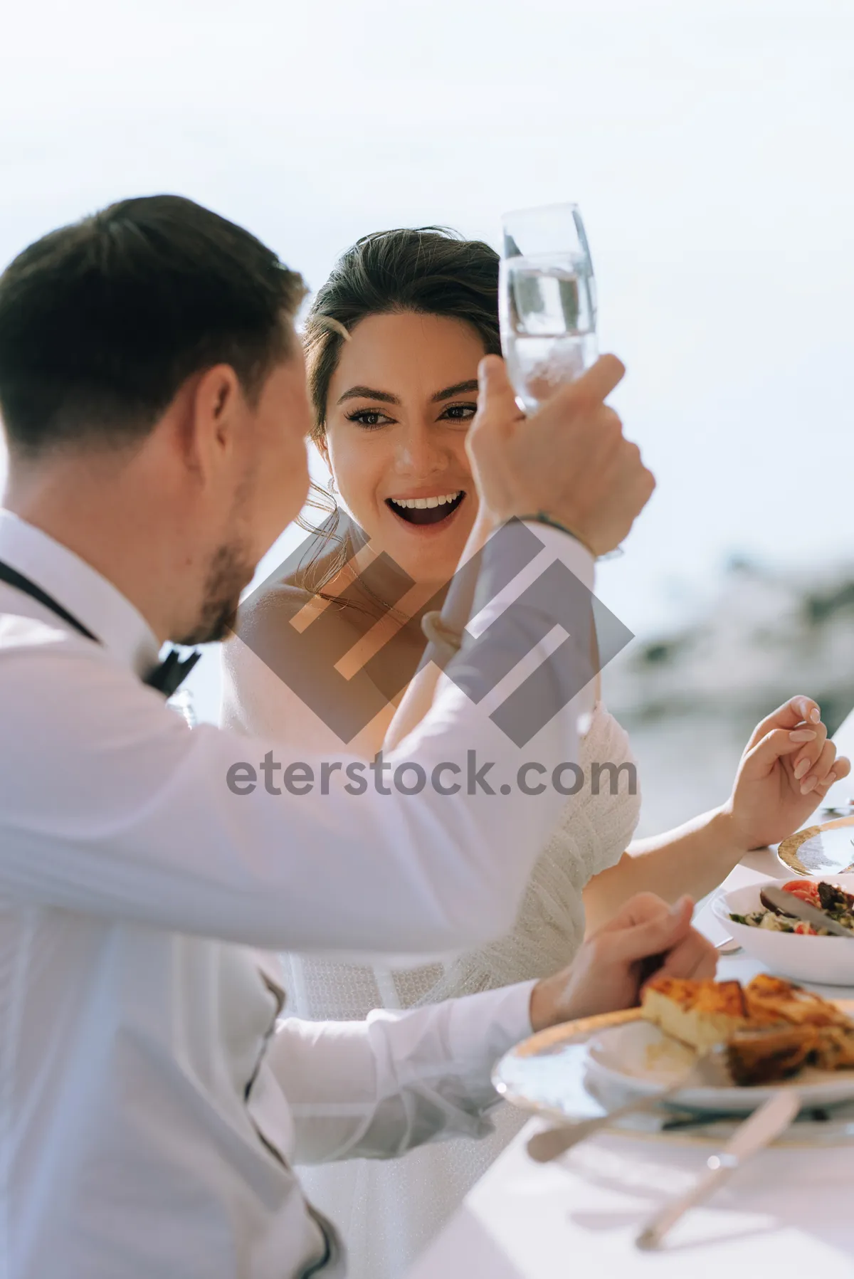 Picture of Happy man smiling while eating meal outdoors.