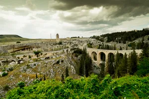 Ancient stone fortress against city skyline and river landscape