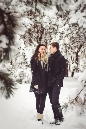 Happy adult enjoying winter snow in park.