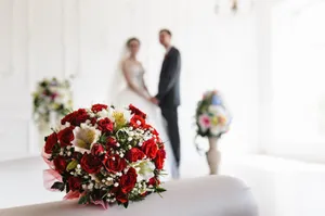 Happy couple celebrating wedding surrounded by beautiful flowers