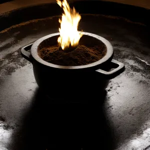 Hot cocoa in black cup with candle