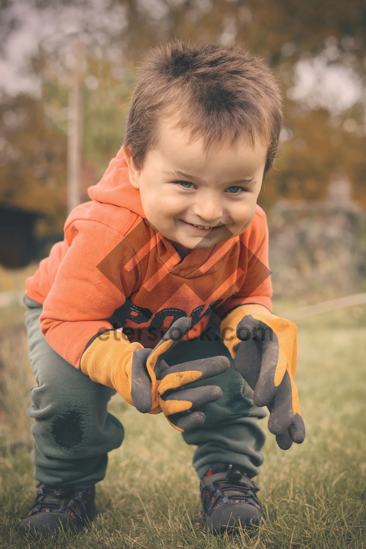 Picture of Happy boy smiling in the park with family