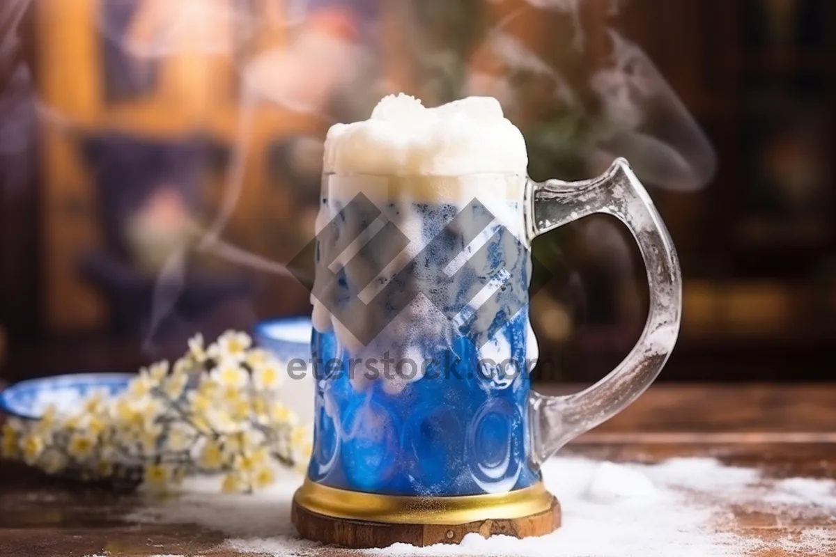 Picture of Amber beer in frothy glass mug.