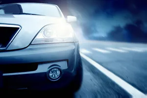 Speedy modern luxury car on highway at night.