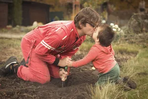 Happy Father and Son Smiling in Park