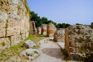 Ancient cemetery ruins with stone walls and graves.